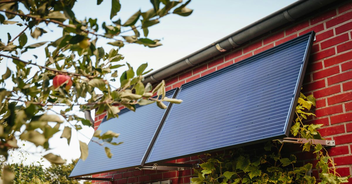 Tenant discussing balcony solar panel installation with landlord
